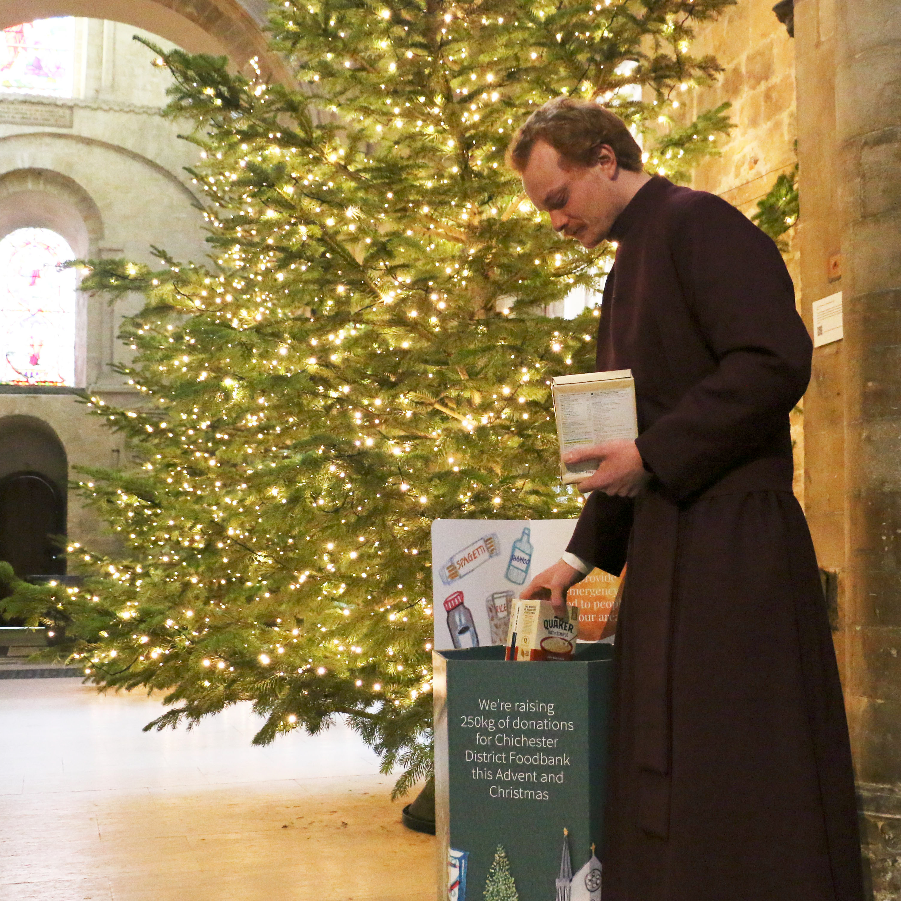 A Verger collects Foodbank donations from our basket