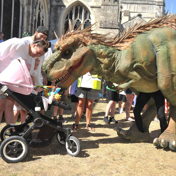 A dinosaur greets a baby