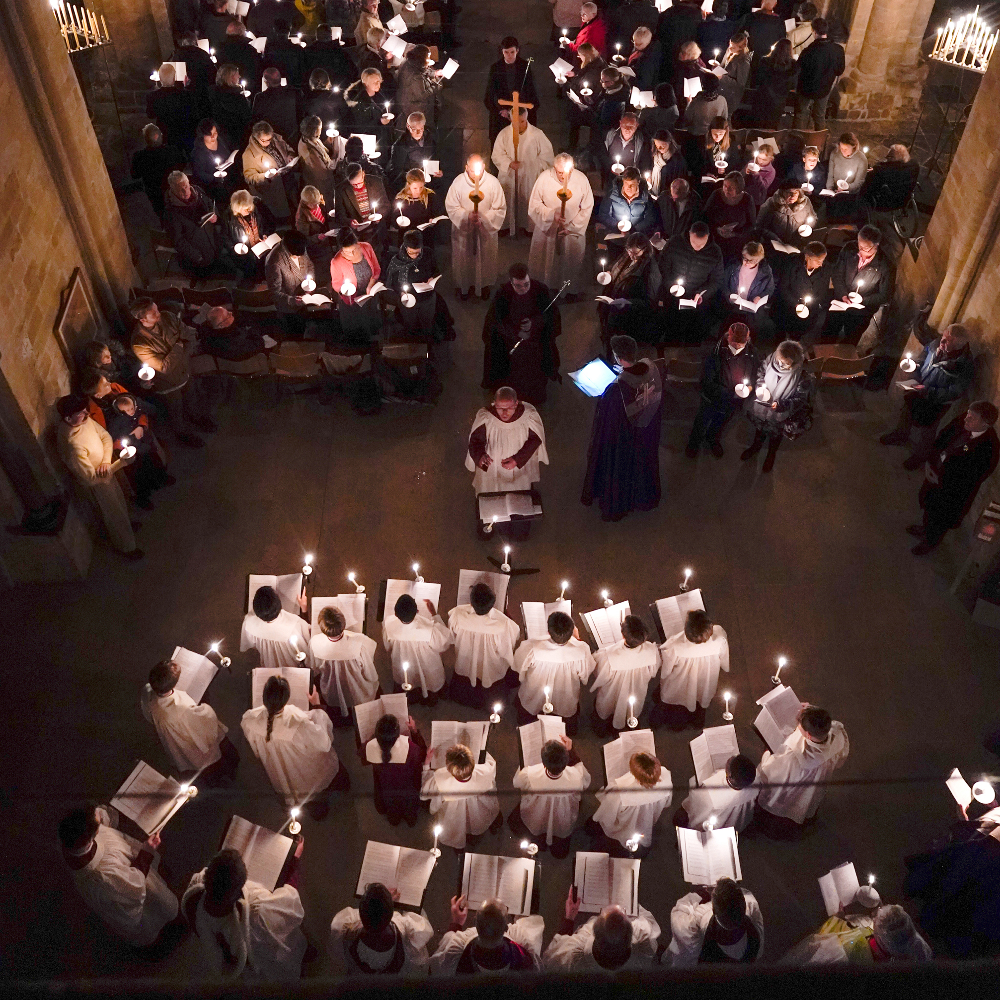 The choir from a birds eye view during the Advent Procession, holding candles